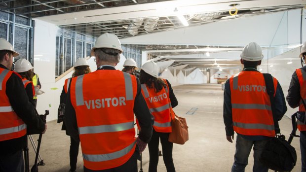 Stephen Byron escorts media on a guided tour of the construction site of the $18 million fitout for the new international terminal.