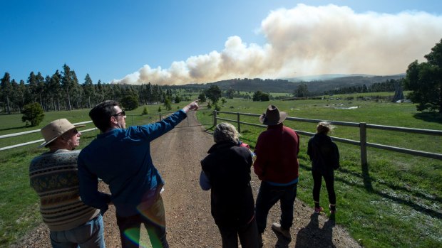 Locals watch helicopters attacking the Lancefield fire in Syd Smith's lane across the gully.