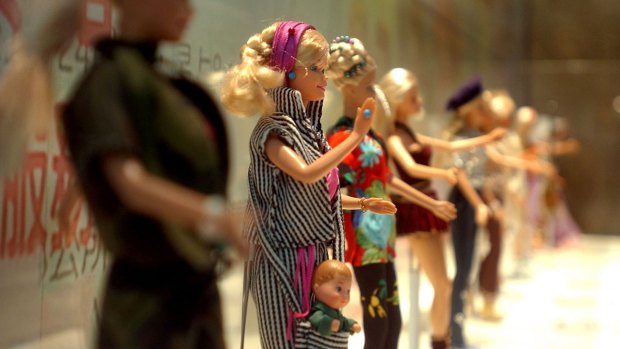 Barbie dolls in various outfits at the makeshift Barbie museum, in 2004. 