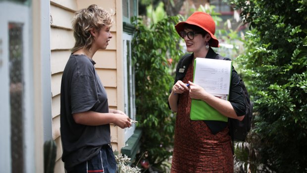 Amy MacMahon (right) doorknocking in her electorate.