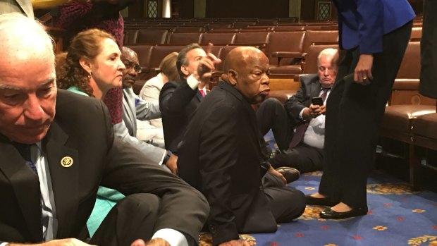 Democrat members of Congress, including Representatives John Lewis, centre, participate in the sit-down protest.