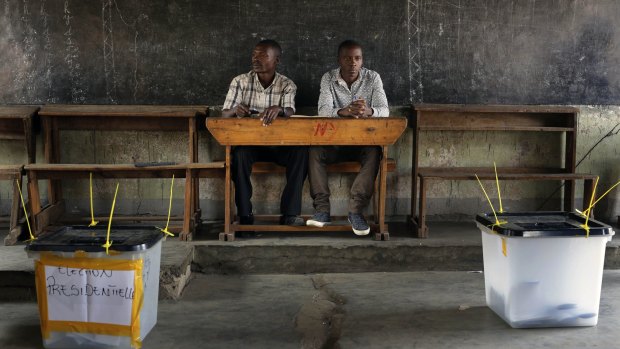 Election observers sit in an empty polling station in Bujumbura.