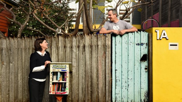 Street librarians Nic Lowe and Kylie Legge at the book exchange outside Lowe's home.