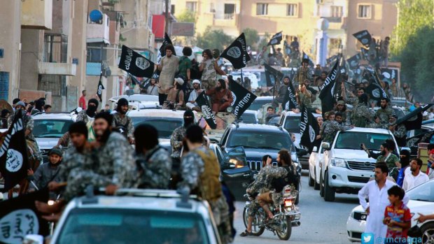 Islamic State militants parade in Raqqa, Syria, the group's de facto capital.
