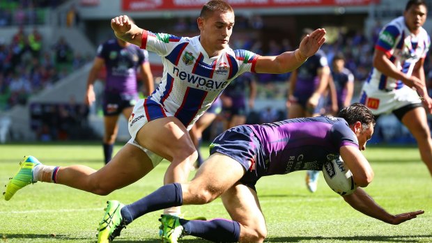 Cooper Cronk of the Storm scores a try against the Newcastle Knights at AAMI Park.
