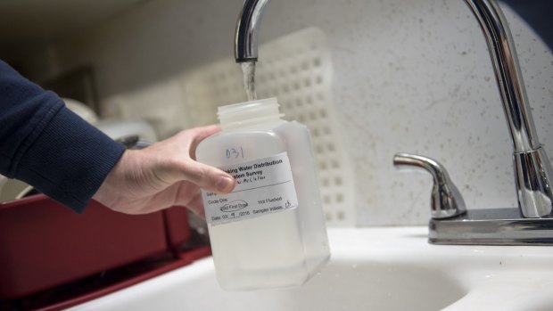 In a photo provided by the university, Virginia Tech researchers test tap water in Flint, Michigan last month.