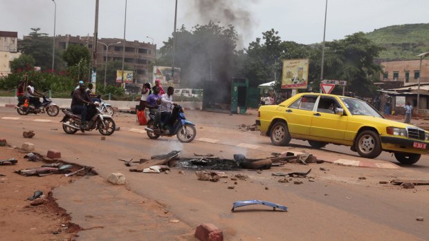 Debris from a burning tyre on a road after a protest against the arrest of a popular activist radio host in Bamako, Mali.