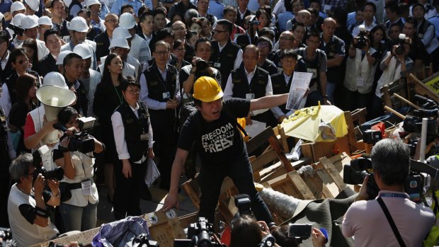 A pro-democracy protester denounces a statement from a lawyer prior to the removal of the barricades blocking Argyle Street in Hong Kong's Mong Kok district.