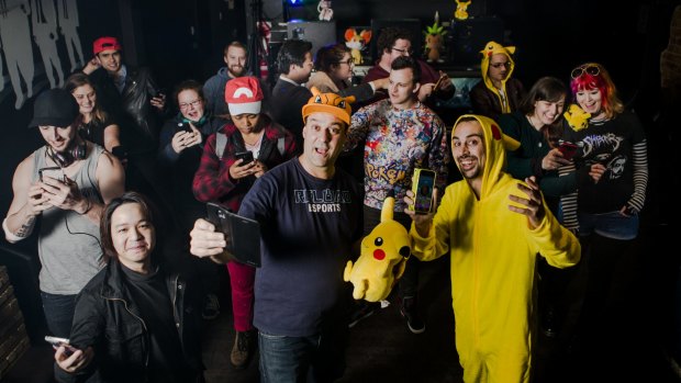 Reload Bar owners Ravi Sharma and Jim Andrews (centre) are banking on the success of Pokemon Go by planting lures and offering themed events, including a Pokepartybus.