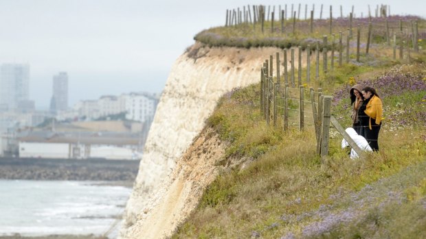 People lay flowers at the clifftop where Arthur Cave fell to his death.