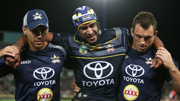 Sorry sight: Johnathan Thurston is helped off the field.