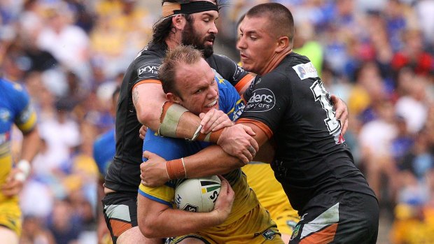 Struggling to avoid Tigers: Eels forward David Gower is tackled during the round four NRL match between the Wests Tigers and the Parramatta Eels at ANZ Stadium.