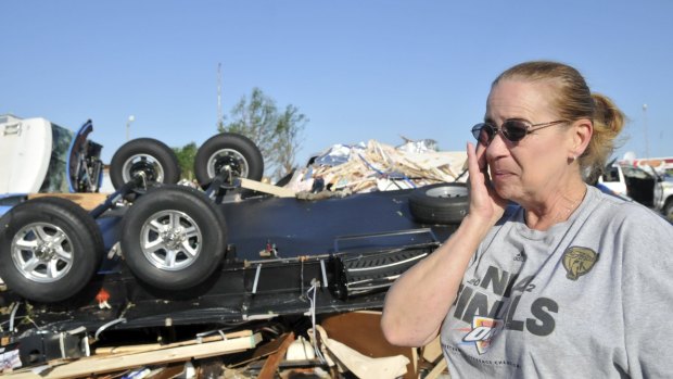 Becky Braley reacts in front of the wreckage left behind after a tornado destroyed her in-laws RV at the Roadrunner RV Park in Oklahoma City.