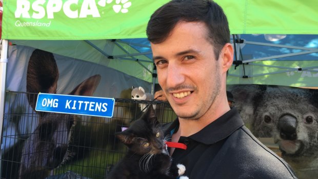 RSPCA volunteer Tim Ferris with RSPCA kitten Figaro at the Ekka, where the funding for the Pets in Crisis program was announced.