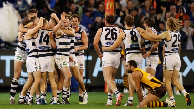 Close call: Geelong players celebrate after Isaac Smith's after-the-siren attempt at goal for the Hawks went wide.