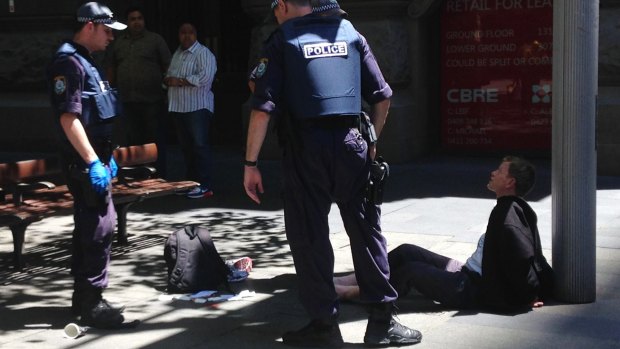 The photo that circulated online, showing a man being arrested 200 metres away from the Lindt cafe in Martin Place.