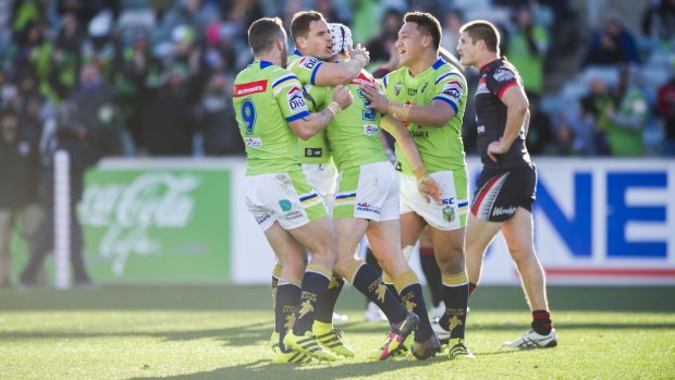 Jarrod Croker celebrates with teammates after he scored his first try. 