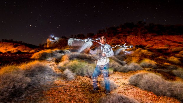 Ecologist Steve Murphy among the spinifex, searching for the elusive night parrot's call.