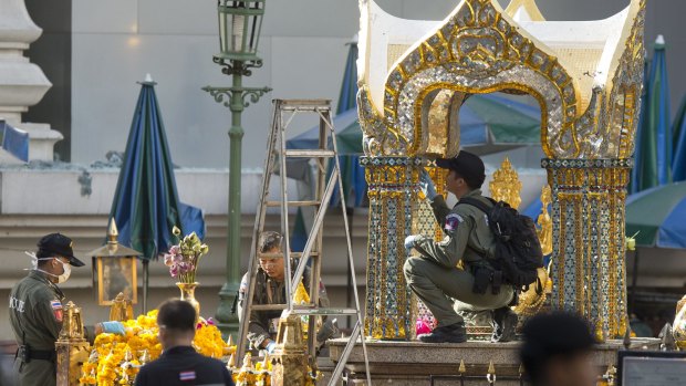 Police investigate the scene around the Erawan Shrine the morning after the explosion in Bangkok.