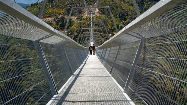 People walk across a narrow footbridge suspended across a river canyon, which claims to be the world’s longest pedestrian bridge, in Arouca, Portugal. 