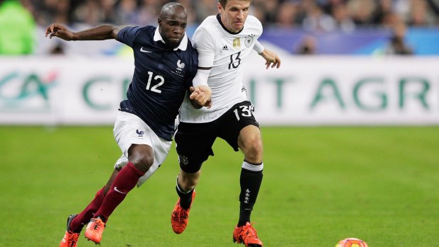 Heavy heart: French footballer Lassana Diarra competes with German opponent Thomas Mueller during the International friendly between France and Germany at the Stade de France on November 13.