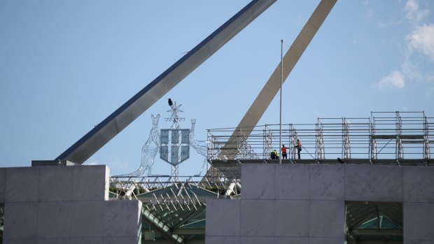 Workers with scaffolding on the roof of Parliament House.