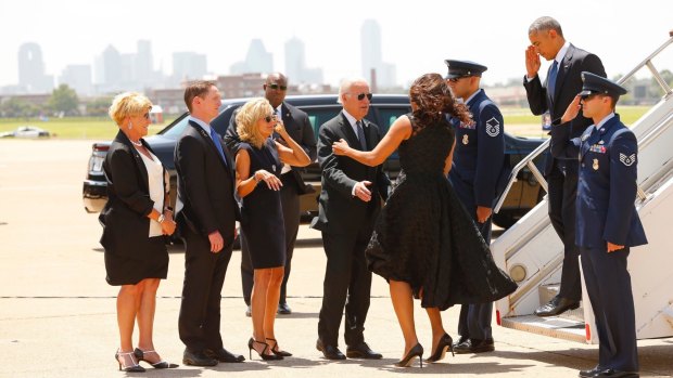 President Barack Obama, right, and first lady Michelle Obama are greeted by local officials in Dallas. The Obamas were joined by Vice-President Joe Biden and his wife Jill Biden. 