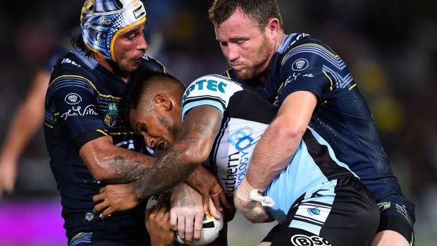 Roped in: Sharks fullback Ben Barba is tackled by the Cowboys.