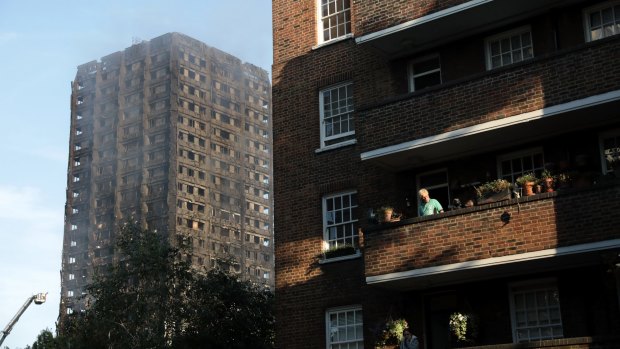 Neighbouring residents look over at the the burning 24-storey Grenfell Tower block in west London.