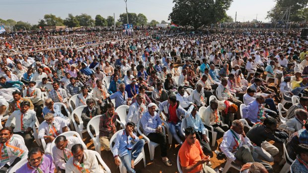 People listen to Rahul Gandhi during an election rally near Bayad in Gujarat state in November.