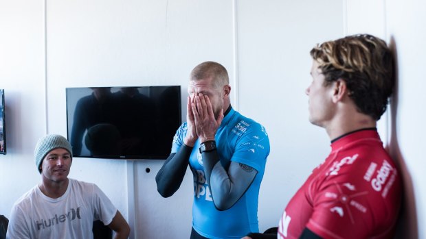 Shaken: Mick Fanning holds his head in his hands taking the gravity of the situation after being attacked by a shark during the JBay Open.