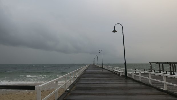 Storm clouds roll in over Port Phillip Bay off Kerferd Road Pier. 