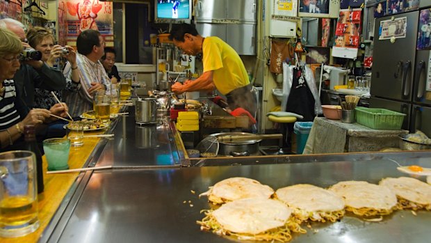 Okonomiyaki (Japanese Pancake) being made at a local outlet. 