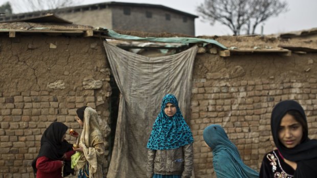 Afghan refugee girls play in a slum on the outskirts of Islamabad, Pakistan.