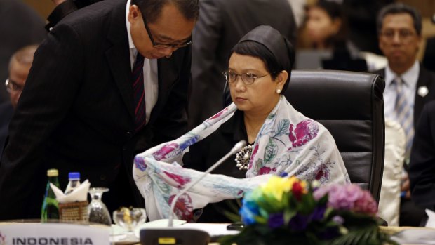Indonesia's Foreign Minister Retno Marsudi listens to a delegation memeber in Kuala Lumpur.
