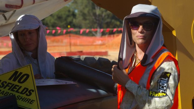 Kerri Tonkin, left, and fellow protester Cyd Fenwick, locked on to an excavator.