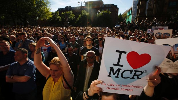 Crowds gather for a vigil in Albert Square, Manchester the day after the suicide attack at an Ariana Grande concert.