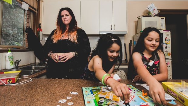 A recent ANU study says overly demanding jobs puts the mental health of employees' kids at risk. Bronwyn Dunn with her daughters Maleeha 7, and Amaiya 11. 