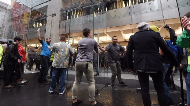 The doors of the Apple store open at 8am to let the relatively small line of enthusiasts in to get the iPhone 6s and 6s Plus.