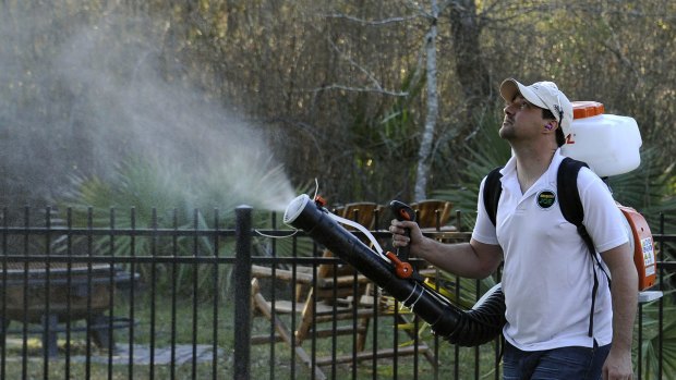 Darryl Nevins, owner of a Mosquito Joe franchise, sprays a backyard to control mosquitoes in Houston, Texas.