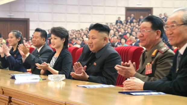 North Korean leader Kim Jong-un, accompanied by his wife Ri Sol-ju, applauds an art performance.