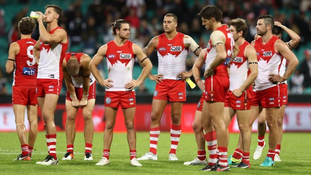 The Swans look dejected after the round three loss to Collingwood.