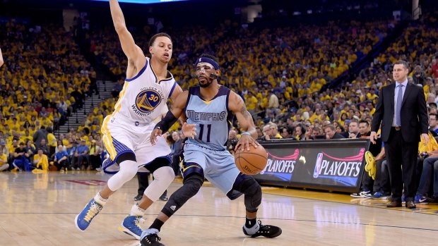 Memphis' Mike Conley  controls the ball against Golden State's Stephen Curry.