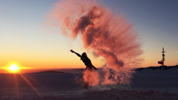 Central Queensland University student Kate Senekin, who has spent nearly a year in Antarctica, doing the 'boiling water trick' at Casey Station.