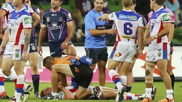 Fateful day: Alex McKinnon receives treatment after the tackle that left him with a broken neck.