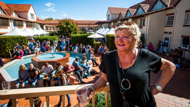 Festival founder Jenny Farrell enjoys a well-earned drink as a record crowd enjoys the sun at the Canberra Craft Beer and Cider Festival. 