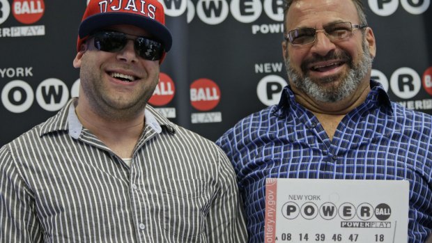 Anthony Perosi, right, holding a copy of the winning Powerball ticket, and his son Anthony with whom he will share the winnings.