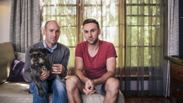 Ben O'Bryan and Michael Romei, with dog Lulu, at their duplex home in Yarralumla.