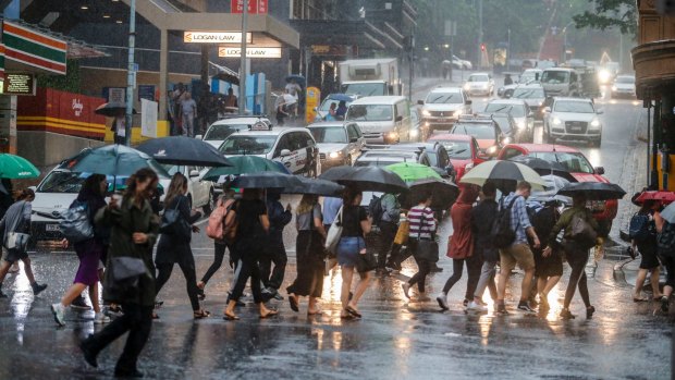 Rainfall brought by ex-cyclone Debbie smashes the Brisbane CBD.