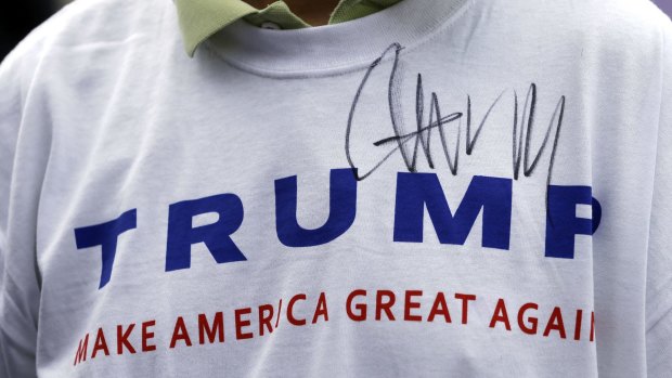 A Trump supporter wearing a t-shirt last month signed by the candidate. 